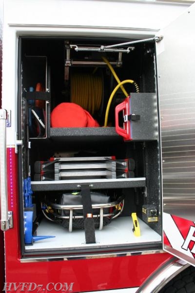 Officers side transverse Compartment.  The Officers bar and hook is located on the bottom shelf.  The little Giant ladder and stokes basket is easy to access from this side.